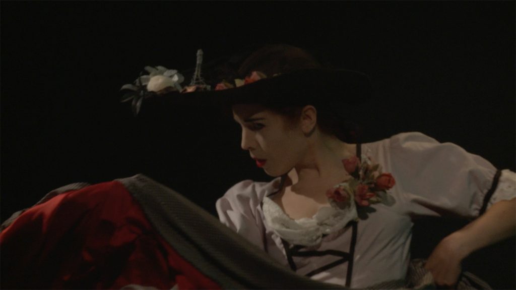 Video still from artwork where artist Maria Norrman interprets and invokes dance artist Jane Avril.
The artist in a dancing pose, dressed in cancan clothing.